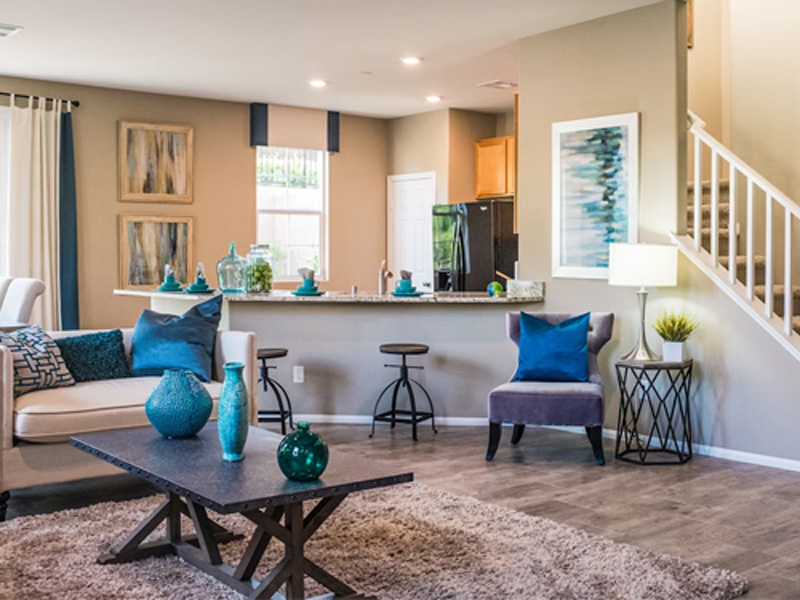 Freshly cleaned open-plan living room and kitchen with colorful blue accents
